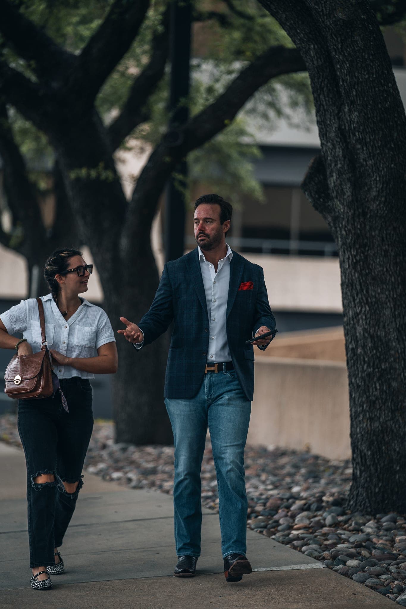 Jonathan Hawkins walking and talking with a client outdoors